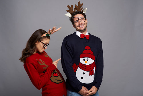 Funny couple posing in Christmas clothes