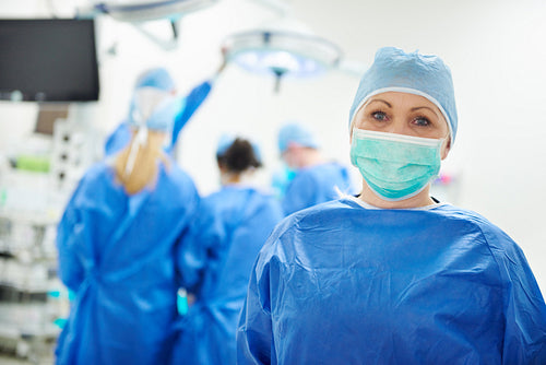 Mature female surgeon with surgical mask