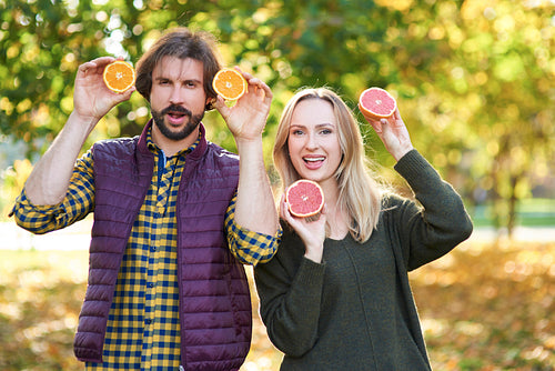 Portrait of couple having fun with fruit