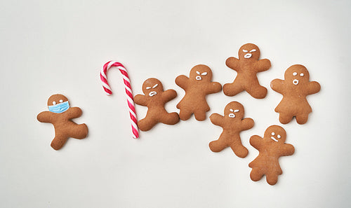 Funny gingerbread man shaped cookies with facial masks