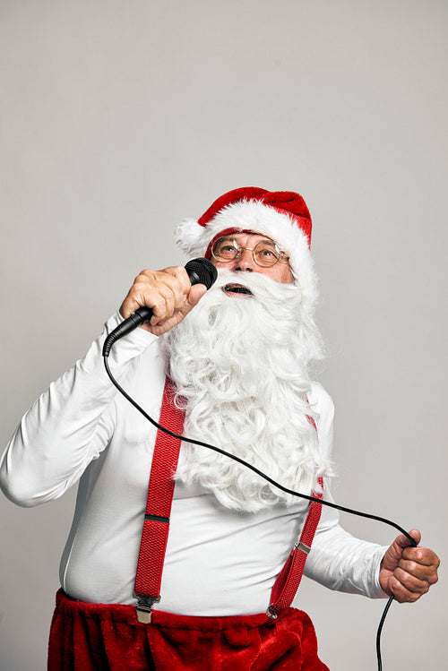 Caucasian Santa Claus singing with microphone