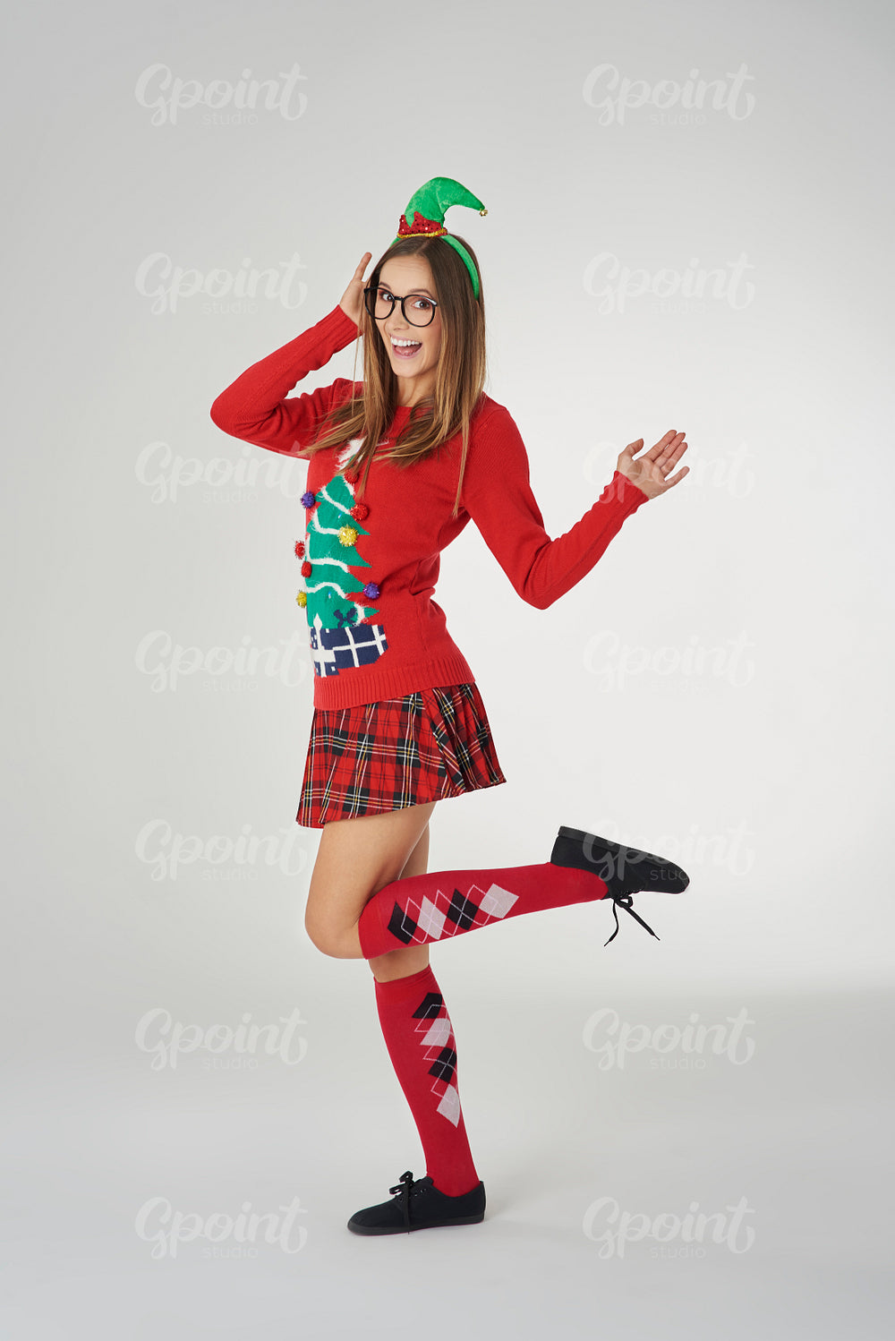 Woman in Christmas clothes on gray background