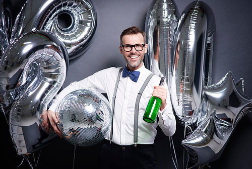 Man with disco ball and bottle of champagne