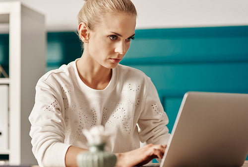 Hard-working woman using laptop at office
