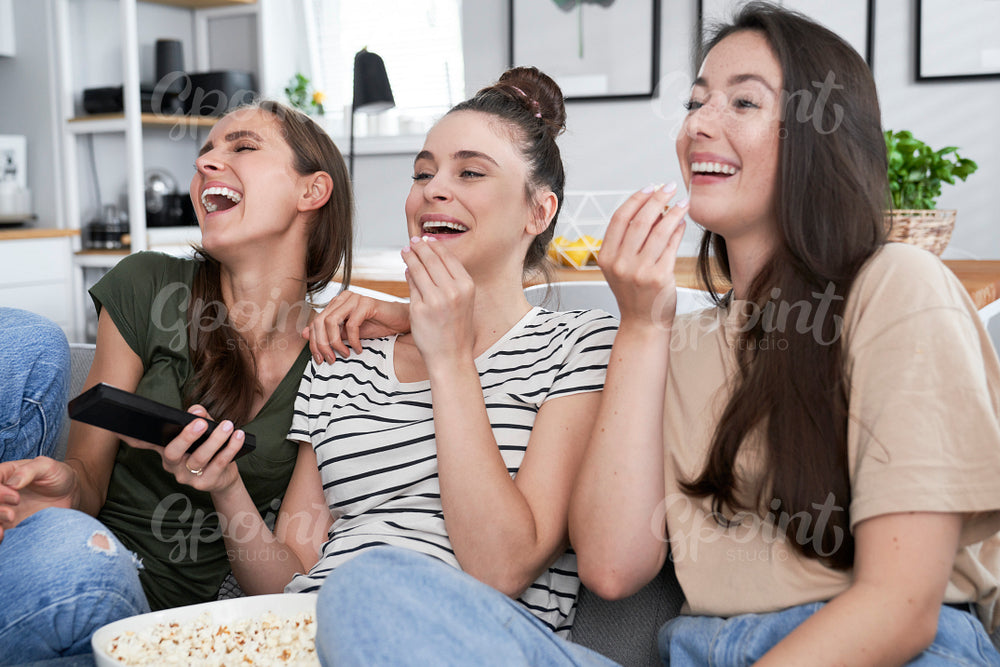 Best friends watching comedy movie at home