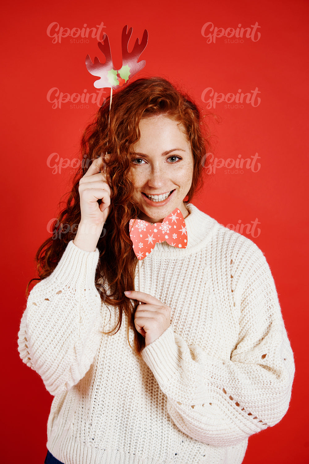 Happy girl in christmas mask on red background