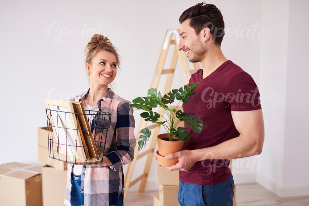 Young couple unpacking boxes of their stuff in new flat