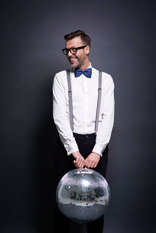 Man with disco ball posing