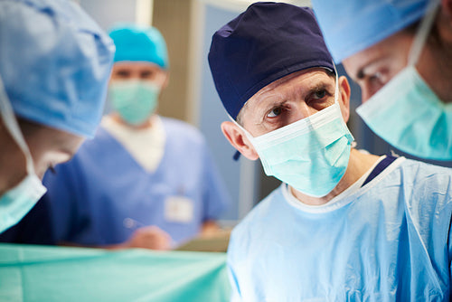 Mature male doctor in operating room