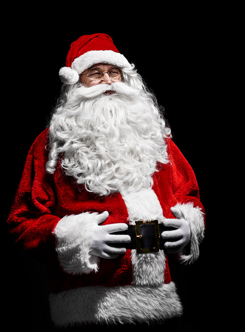 Portrait of cheerful santa claus with hands on stomach