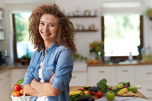 Portrait of smiling woman in her kitchen
