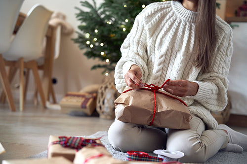 Low section of woman packing Christmas presents
