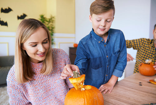 Parent and child making carved pumpkin