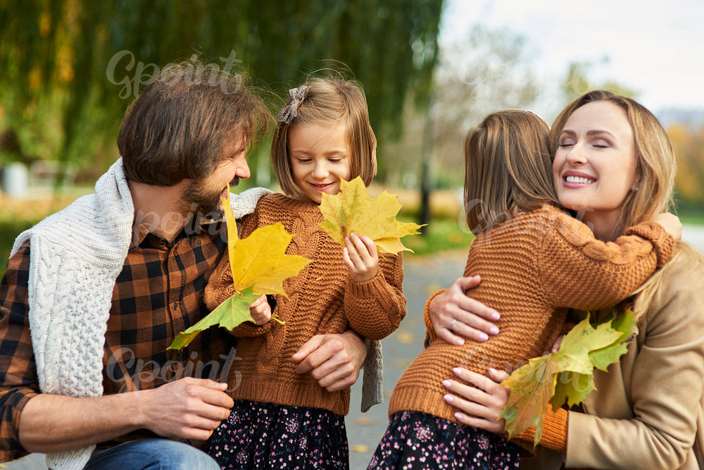 Cheerful scene of family in autumn forest