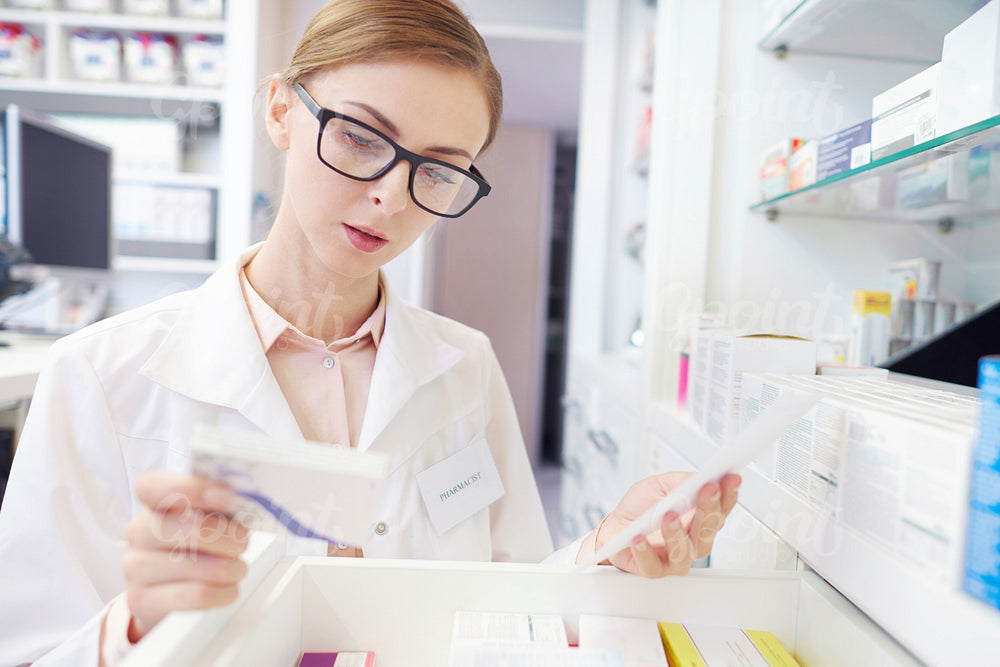 Close up of busy female pharmacist