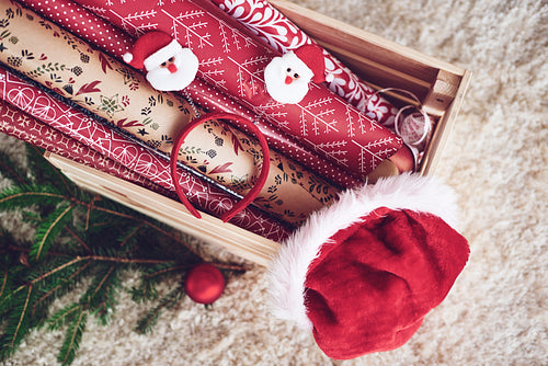 Wooden crate with christmas paper and santa hat