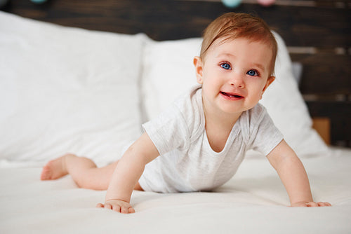 Portrait of baby crawling on the bed