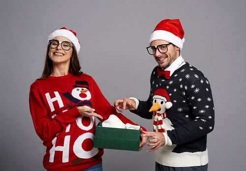 Funny couple opening Christmas gift