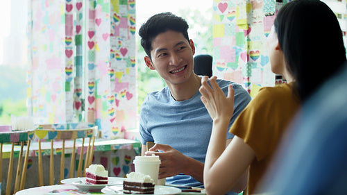 Handheld view of young couple in a cafe.