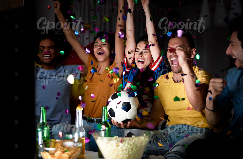 Football fans celebrating victory of their team in the evening