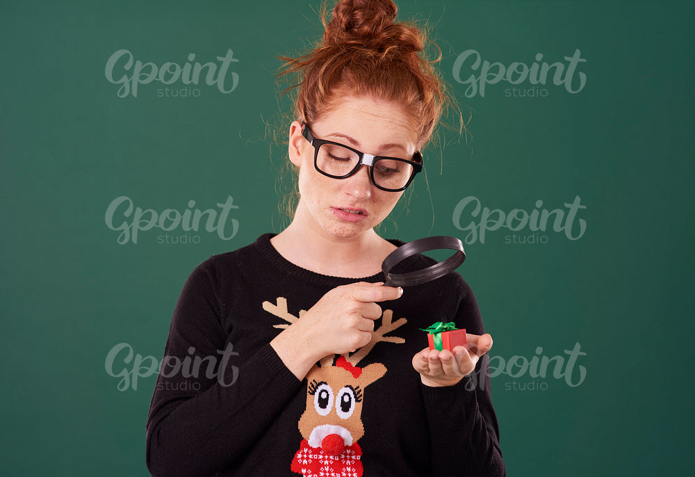 Disappointed woman looking at tiny present