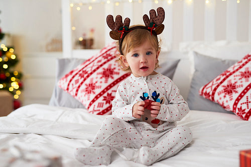 Portrait of charming baby with Christmas gift