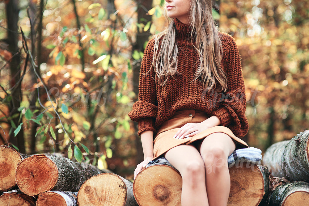 Fashionable young woman in autumn woods