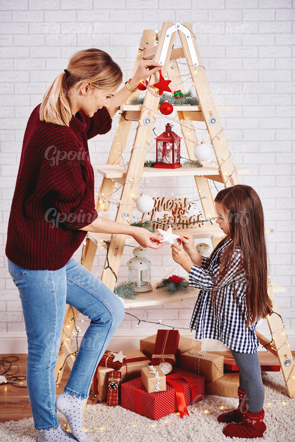 Mother and daughter decorating the christmas tree