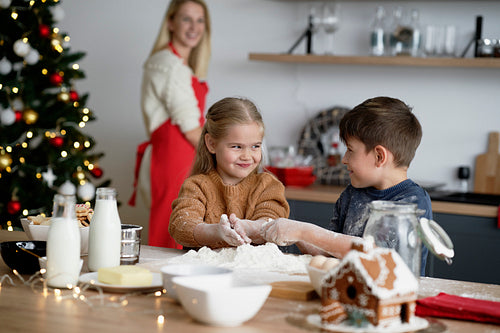Children having great fun while baking cookies for Christmas