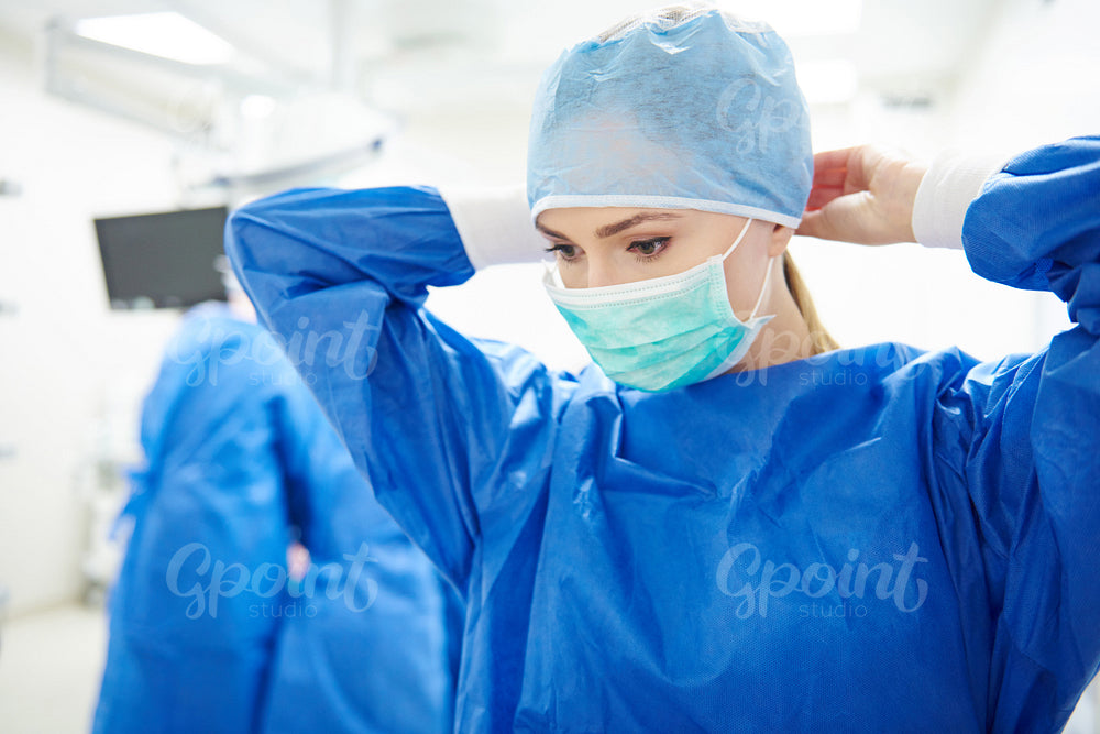 Young doctor during preparation for operation