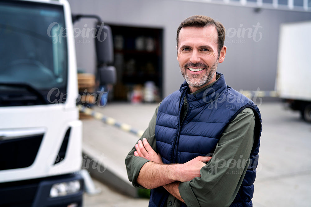 Portrait of caucasian mature man in front of warehouse 