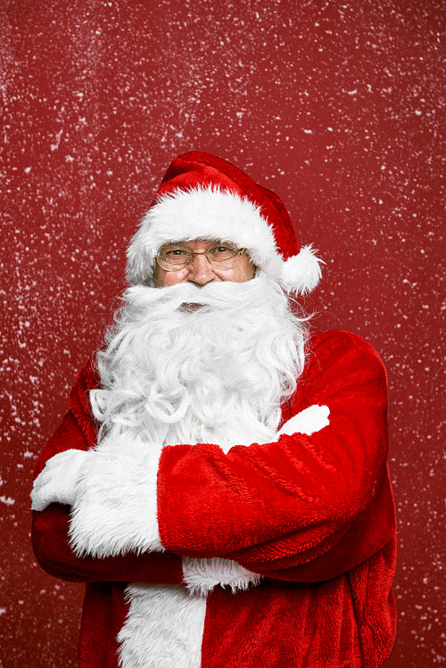 Caucasian Santa Claus on red background with snow