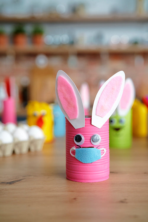 Handmade Easter rabbit in protective face mask on the table