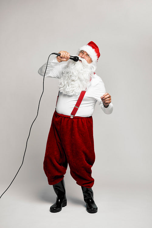 Caucasian Santa Claus singing with microphone