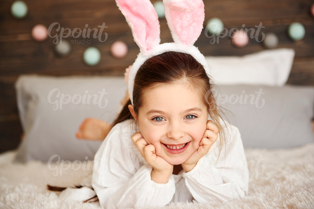 Smiling girl lying on the bed