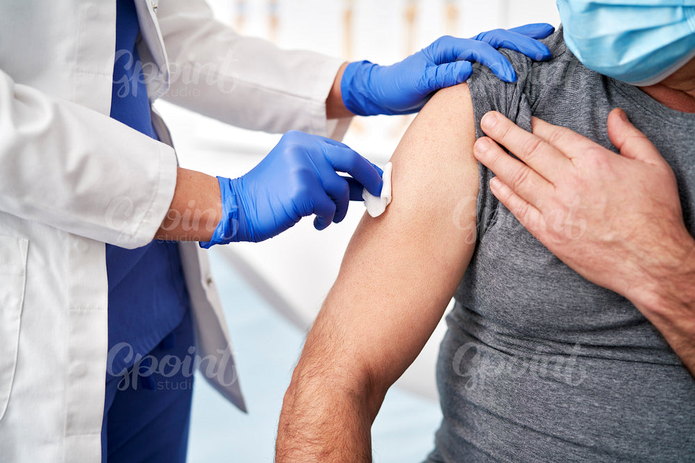 Close up of prepares a patient for vaccination