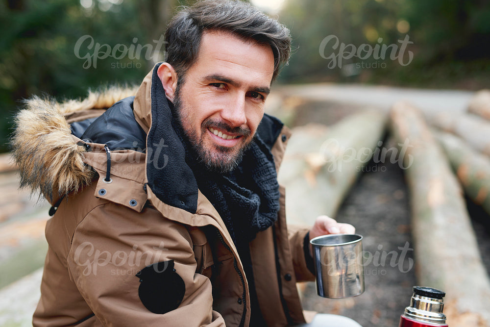 Portrait of handsome man in forest in wintertime