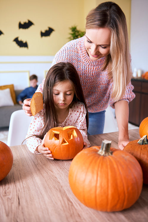 Girl carving pumpkin for Halloween