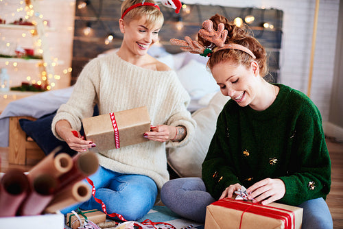 Young women preparing christmas gifts