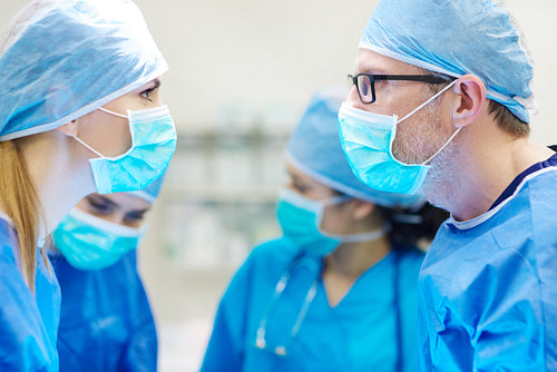 Two surgeons standing face to face