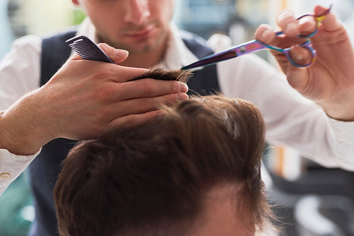 Close up of man has cutting hair at the hairdresser