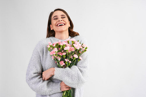 Joyful woman with bunch of pink cloves