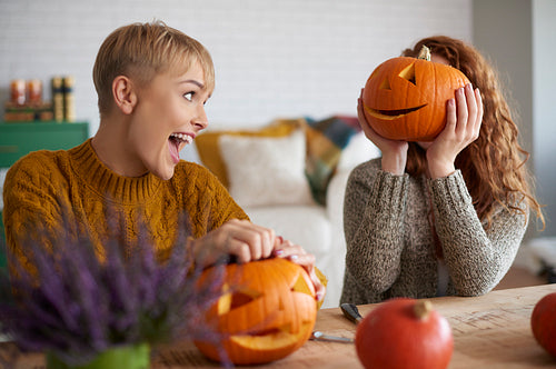 Funny girls carving pumpkins for halloween
