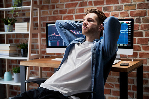 Adult man sitting at home office and thinking about business