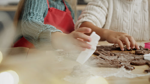Handheld video of children cutting out gingerbread cookies