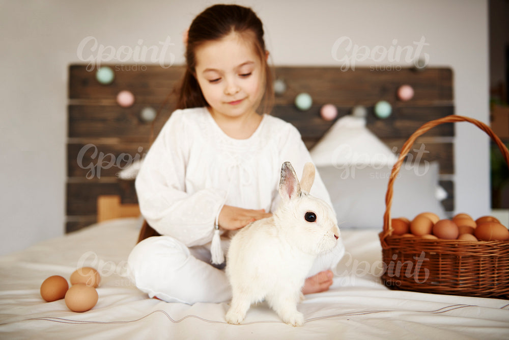 Affectionate child stroking the rabbit