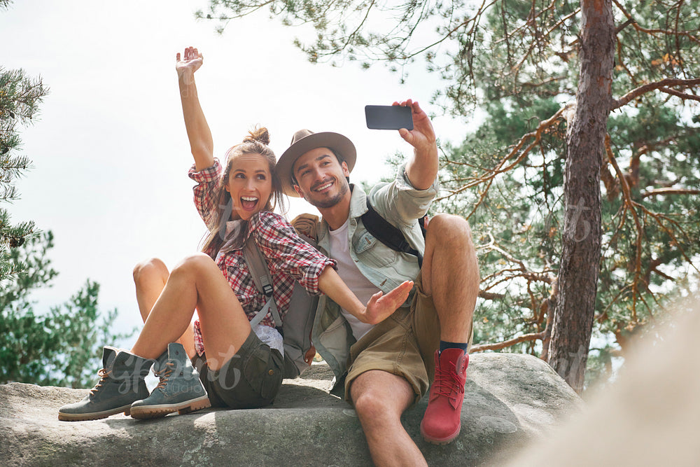 Young couple making a selfie during hiking trip