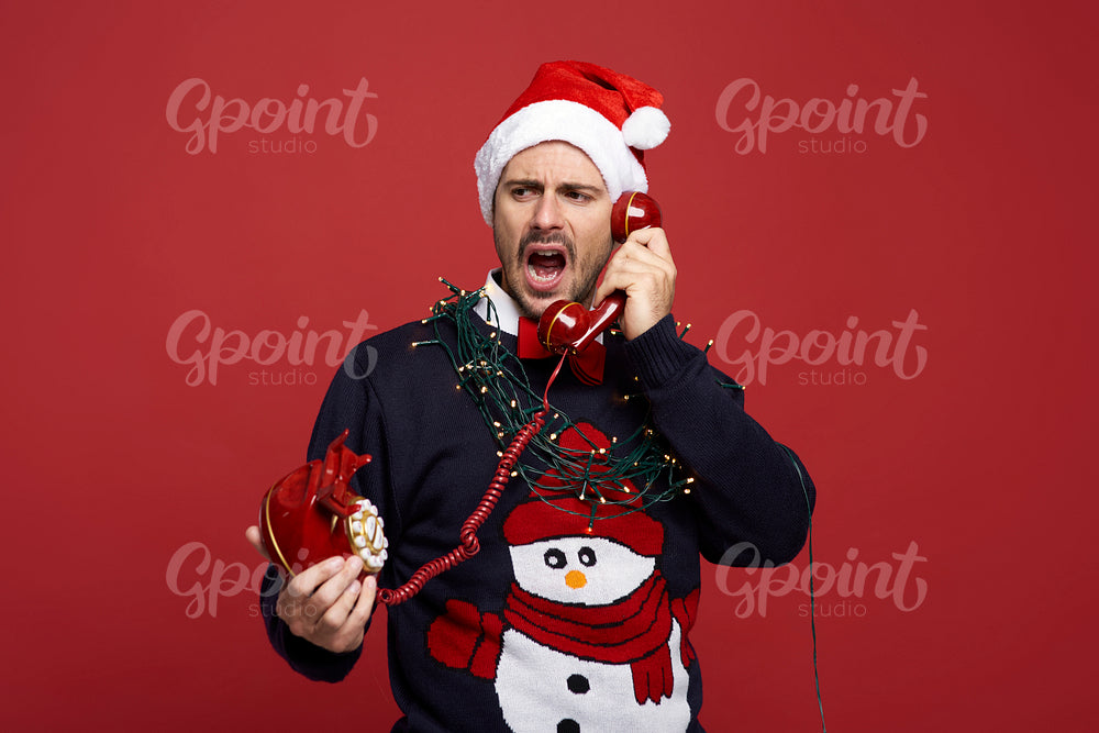 Frustrated man with stationary phone