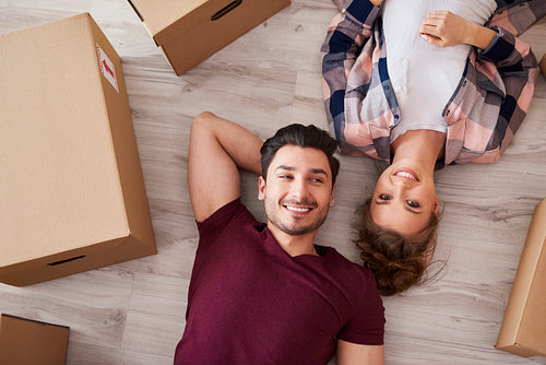 Portrait of smiling couple taking break from moving home