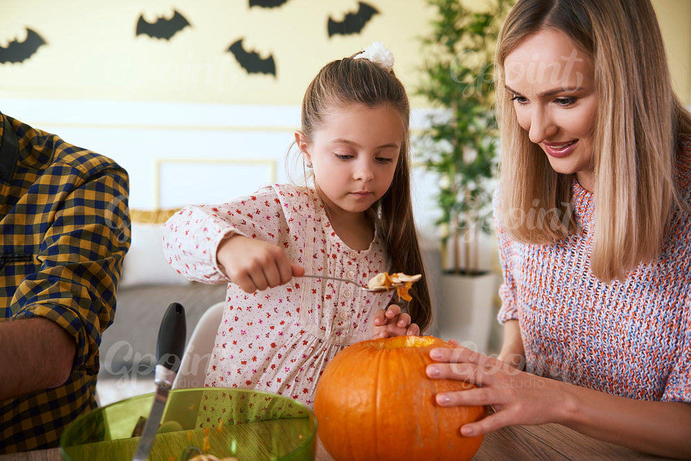 Mother and daughter carving pumpkin